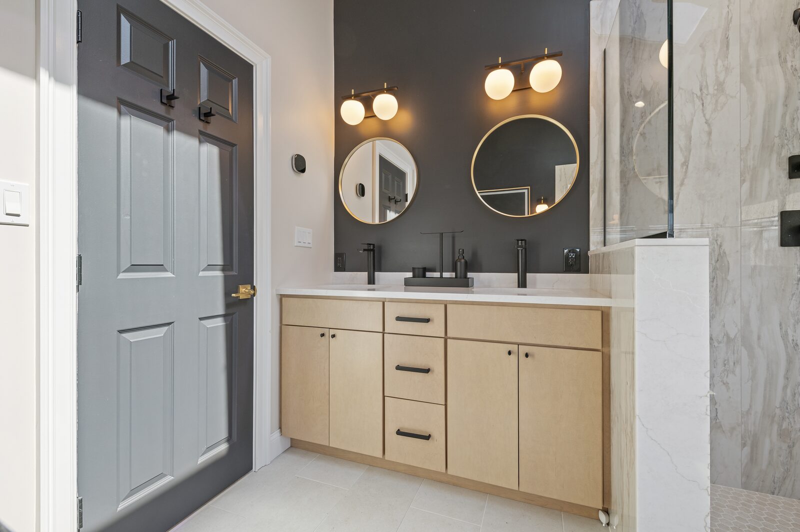 Light wood double vanity against a dark accent wall