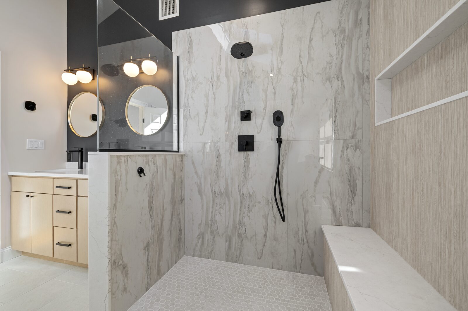 Marble walk-in shower with a built-in bench