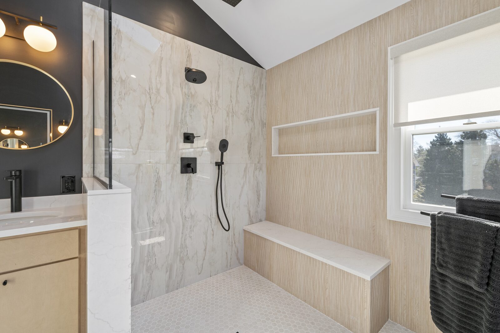 Large tiled shower with a built-in bench